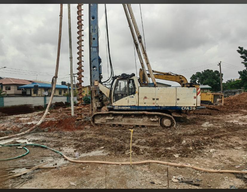 Soilmec CFA26 piling rig working a cleared plot with an excavator behind