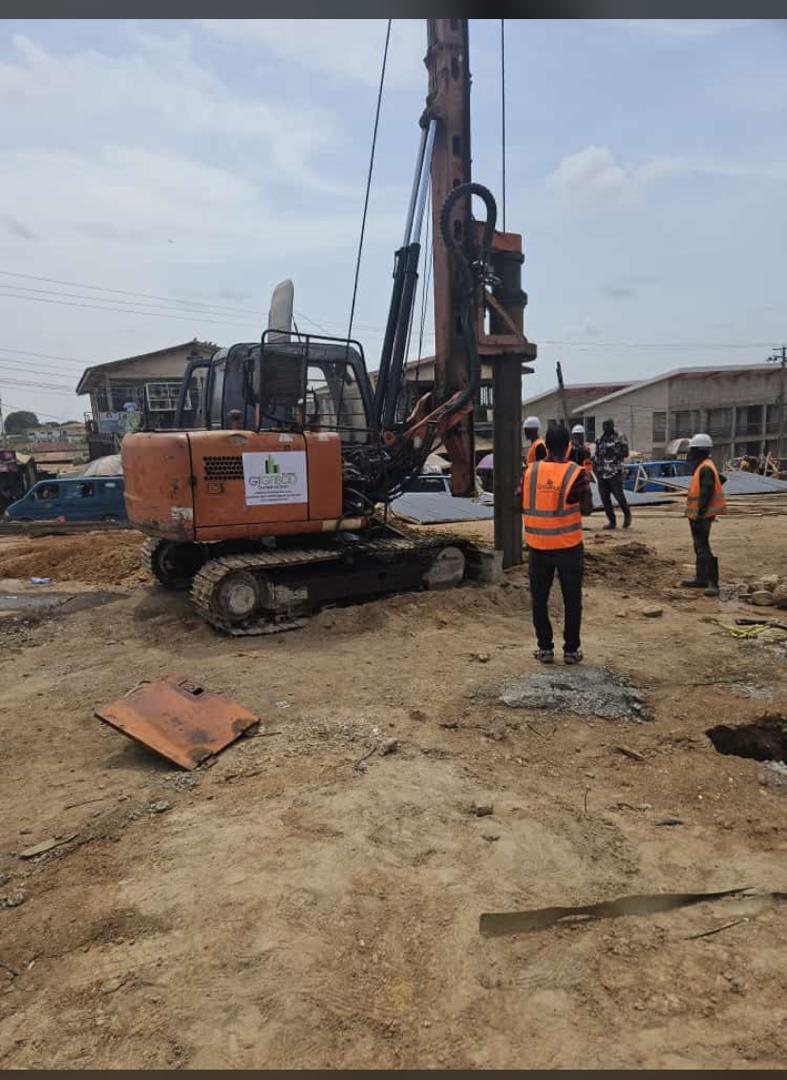 GTGABOD rotary piling rig and crew in hi-vis working a street-side site in Lagos